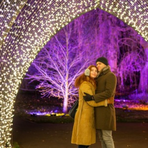 A Couple in a tunnel of lights at Christmas